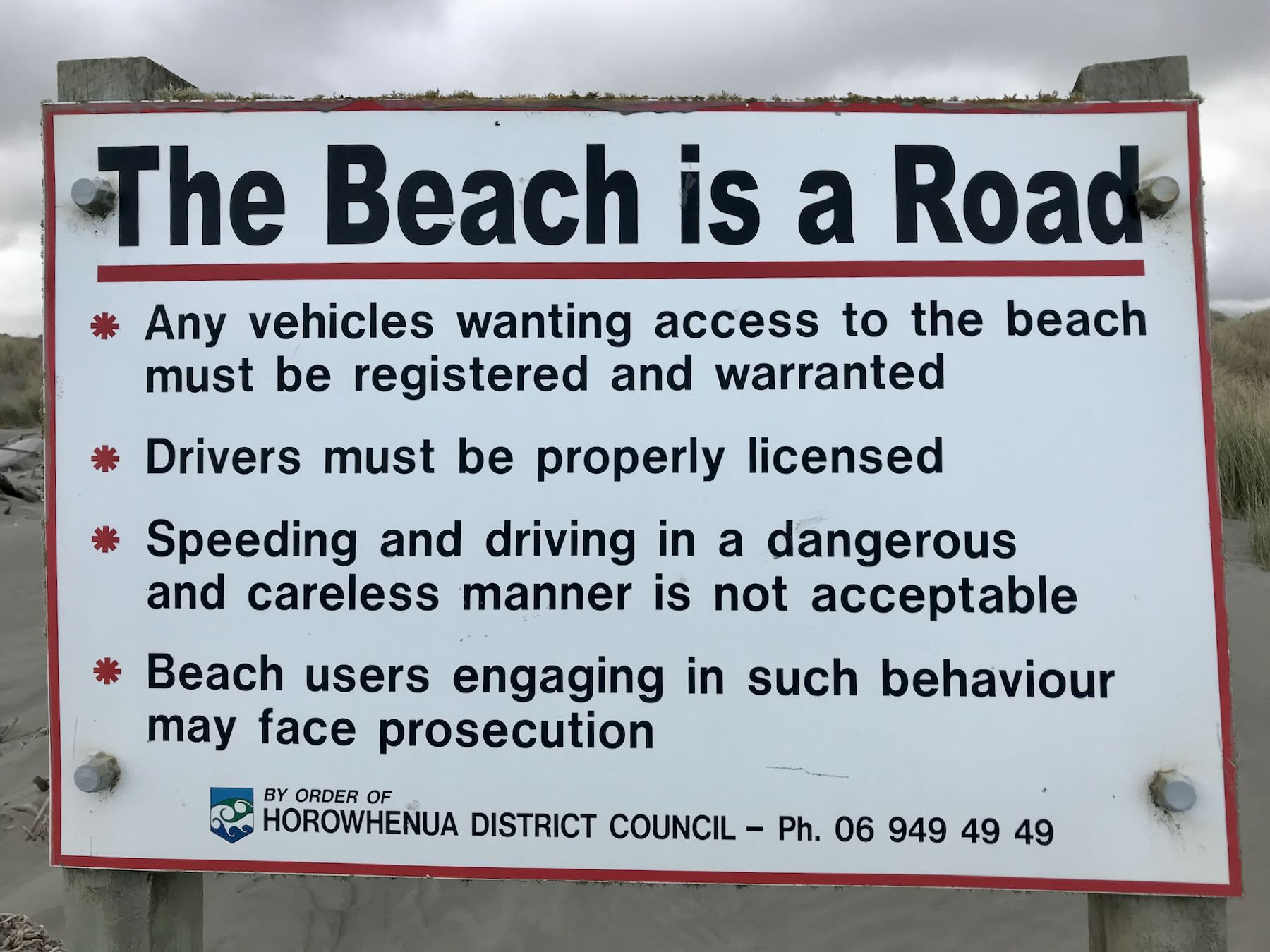 Sign in the Waikawa Beach dunes that the beach is a road. 